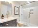 Updated bathroom with white tile shower, sleek glass doors, and modern fixtures at 1301 Flying Hawk Rd, Apex, NC 27523
