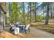 Inviting deck with wooded view, string lights, and outdoor seating at 1301 Flying Hawk Rd, Apex, NC 27523