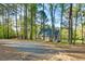 Long driveway leading to a charming home surrounded by mature trees and natural beauty at 1301 Flying Hawk Rd, Apex, NC 27523