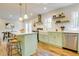 Well-lit kitchen with island seating, stainless appliances, and modern finishes at 1301 Flying Hawk Rd, Apex, NC 27523