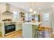 Charming eat-in kitchen featuring stainless appliances, island with seating, and farmhouse sink at 1301 Flying Hawk Rd, Apex, NC 27523