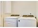 Convenient laundry room with side-by-side front load washer and dryer at 1301 Flying Hawk Rd, Apex, NC 27523