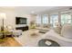 Cozy living room with hardwood floors, plush sofas, and natural light at 1301 Flying Hawk Rd, Apex, NC 27523