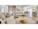 Bright living room featuring neutral tones, plush seating, and stylish decor at 1301 Flying Hawk Rd, Apex, NC 27523