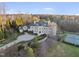 Aerial view of an expansive estate with manicured lawns, a private tennis court, and mature trees at 1404 Barony Lake Way, Raleigh, NC 27614