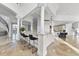 Elegant bar area featuring marble countertops, black bar stools, and decorative pillars at 1404 Barony Lake Way, Raleigh, NC 27614