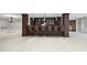 Basement bar with dark wood cabinets, pendant lights, and barstool seating ideal for entertaining guests at 1404 Barony Lake Way, Raleigh, NC 27614