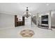 Expansive basement with a bar, decorative tile flooring, statement chandelier, and staircase, perfect for entertaining at 1404 Barony Lake Way, Raleigh, NC 27614