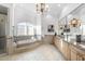 A spacious bathroom with a large vanity, decorative mirror, soaking tub, and walk in shower at 1404 Barony Lake Way, Raleigh, NC 27614