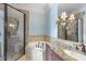 Well-lit bathroom with granite counters, a shower, and a tub for a relaxing at home spa at 1404 Barony Lake Way, Raleigh, NC 27614