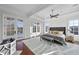 A stunning bedroom with tray ceilings, a ceiling fan, and a view of the lake from the double doors at 1404 Barony Lake Way, Raleigh, NC 27614