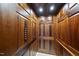 Elegant wood-paneled elevator interior with detailed craftsmanship providing convenient access throughout the home at 1404 Barony Lake Way, Raleigh, NC 27614