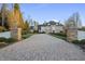 Grand estate with a long private driveway, stone pillars, manicured lawns, and tasteful landscaping at 1404 Barony Lake Way, Raleigh, NC 27614