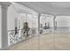 A bright and spacious foyer featuring marble floors, ornate wrought iron railing, and decorative columns at 1404 Barony Lake Way, Raleigh, NC 27614