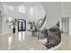 Grand foyer features soaring ceilings, a spiral staircase, marble floors, and elegant decor at 1404 Barony Lake Way, Raleigh, NC 27614
