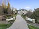 Stately home with a long private driveway, stone pillars, manicured lawns, and tasteful landscaping at 1404 Barony Lake Way, Raleigh, NC 27614