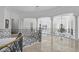 Upstairs hallway with wrought iron railing, decorative columns and light tile floors at 1404 Barony Lake Way, Raleigh, NC 27614