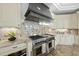 Modern kitchen with professional grade stainless steel stove, granite counters and custom cabinets at 1404 Barony Lake Way, Raleigh, NC 27614