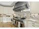 Modern kitchen with professional grade stainless steel range, granite counters and custom cabinets at 1404 Barony Lake Way, Raleigh, NC 27614