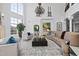 Bright living room with high ceilings, large windows and elegant chandelier, perfect for entertaining at 1404 Barony Lake Way, Raleigh, NC 27614