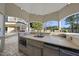 Outdoor kitchen with stainless steel appliances and a stone countertop, perfect for outdoor dining and entertaining at 1404 Barony Lake Way, Raleigh, NC 27614