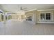 Outdoor patio featuring a stone fireplace, ceiling fan, and a tiled floor, offering a cozy outdoor living space at 1404 Barony Lake Way, Raleigh, NC 27614