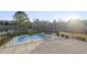 View of backyard showcasing the freeform pool, jacuzzi, lush landscaping, and neighboring pond at 1404 Barony Lake Way, Raleigh, NC 27614