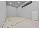 Spacious racquetball court featuring hardwood floors and ample lighting, perfect for fitness and recreation at 1404 Barony Lake Way, Raleigh, NC 27614