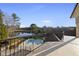 Balcony view overlooking the backyard pool, spa, and a peaceful lake surrounded by mature trees at 1404 Barony Lake Way, Raleigh, NC 27614