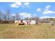 View of the backyard with a deck and a red door at 1425 Country Pond Ln, Willow Springs, NC 27592