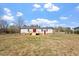View of backyard with ranch style home and chain link fence at 1425 Country Pond Ln, Willow Springs, NC 27592