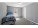 Cozy bedroom with carpet, a single bed and simple decor providing a calming atmosphere at 1425 Country Pond Ln, Willow Springs, NC 27592