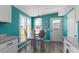 Bright and sunny breakfast nook with custom chairs and a round glass top table at 1425 Country Pond Ln, Willow Springs, NC 27592