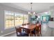 Sunlit dining area featuring a wooden table and large windows with views of the expansive yard at 1425 Country Pond Ln, Willow Springs, NC 27592