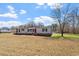 Single-story home with a well-manicured front yard, complete with a red front door at 1425 Country Pond Ln, Willow Springs, NC 27592