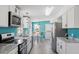 Stylish kitchen featuring white cabinets, granite countertops, and stainless steel appliances at 1425 Country Pond Ln, Willow Springs, NC 27592