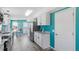 Bright kitchen with white cabinets, modern appliances, granite countertops, and teal accent wall at 1425 Country Pond Ln, Willow Springs, NC 27592