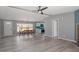 An open-concept living space with gray walls, a dining area, and durable wood floors, creating a modern and inviting atmosphere at 1425 Country Pond Ln, Willow Springs, NC 27592