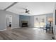 Comfortable living room featuring a charming fireplace, sleek flooring, and access to outdoor spaces for versatile living at 1425 Country Pond Ln, Willow Springs, NC 27592