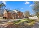 Back of house showing brick construction with a large backyard and plenty of space for outdoor activities at 1506 N Mebane St, Burlington, NC 27217