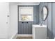 Cozy bathroom with a single vanity and a shower and tub combo gets natural light from a window at 1506 N Mebane St, Burlington, NC 27217