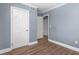 Bedroom with wood floors showcasing an entrance to the bathroom and closet at 1506 N Mebane St, Burlington, NC 27217