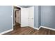 Bedroom with wood floors showcasing an entrance to the bathroom and closet at 1506 N Mebane St, Burlington, NC 27217