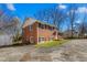 A two-story brick house features classic architecture and a neat landscape at 1506 N Mebane St, Burlington, NC 27217