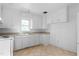 Kitchen featuring bright white cabinetry, tile floors, and modern appliances at 1506 N Mebane St, Burlington, NC 27217
