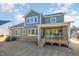 View of the home's backyard showcasing a covered outdoor living space and exterior paint color at 1515 Spring Overlook Ln, Hillsborough, NC 27278