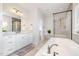 Bright bathroom featuring a large vanity with double sinks and a glass-enclosed shower with a separate soaking tub at 1515 Spring Overlook Ln, Hillsborough, NC 27278