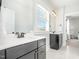This bright bathroom features double sinks with dark vanities and two large, framed mirrors at 1515 Spring Overlook Ln, Hillsborough, NC 27278