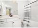 Clean bathroom features a vanity with a large mirror and a tub and shower combination with a stylish striped curtain at 1515 Spring Overlook Ln, Hillsborough, NC 27278