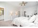 Light and airy bedroom featuring a large bed, dresser, and desk next to three open doorways at 1515 Spring Overlook Ln, Hillsborough, NC 27278